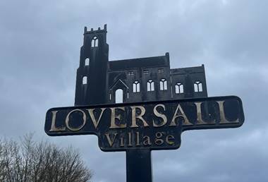 A sign with a castle in the background
Description automatically generated